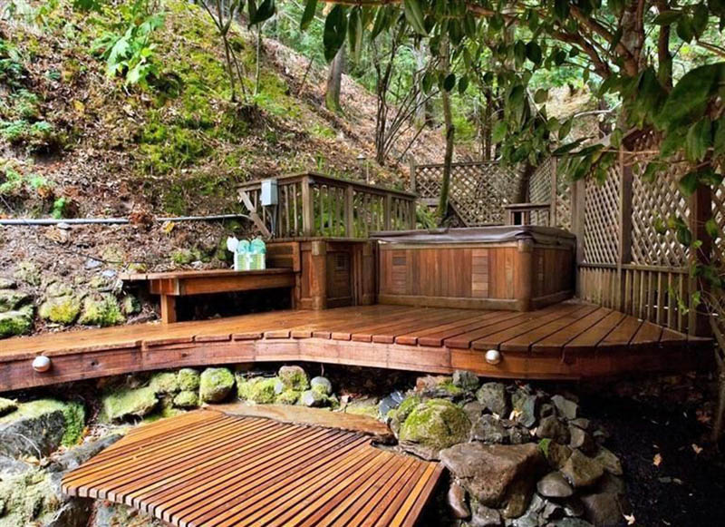 Backyard deck with elevated hot tub and fence