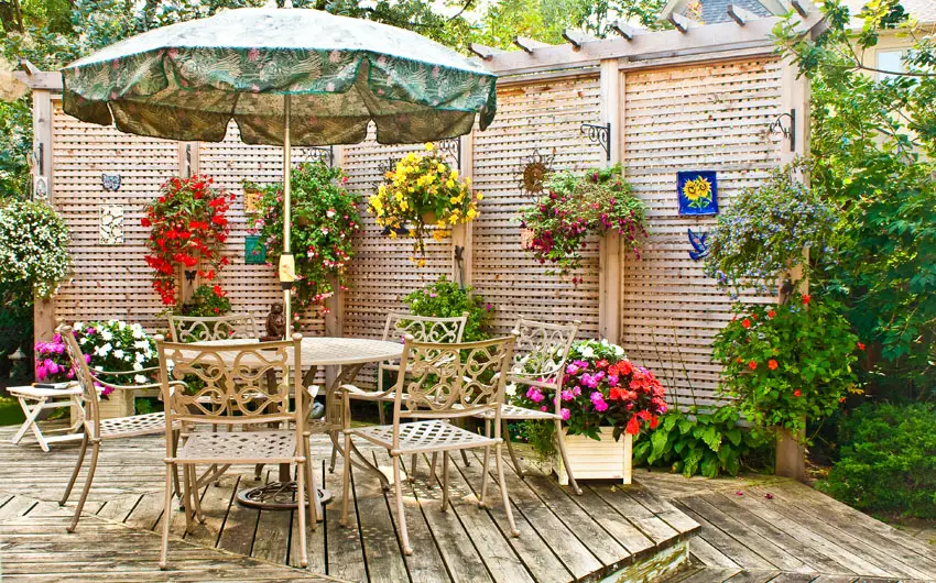 Backyard deck with wood lattice and hanging plant boxes with flowers