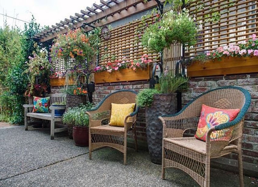 Backyard patio with wood flower boxes and narrow pergola