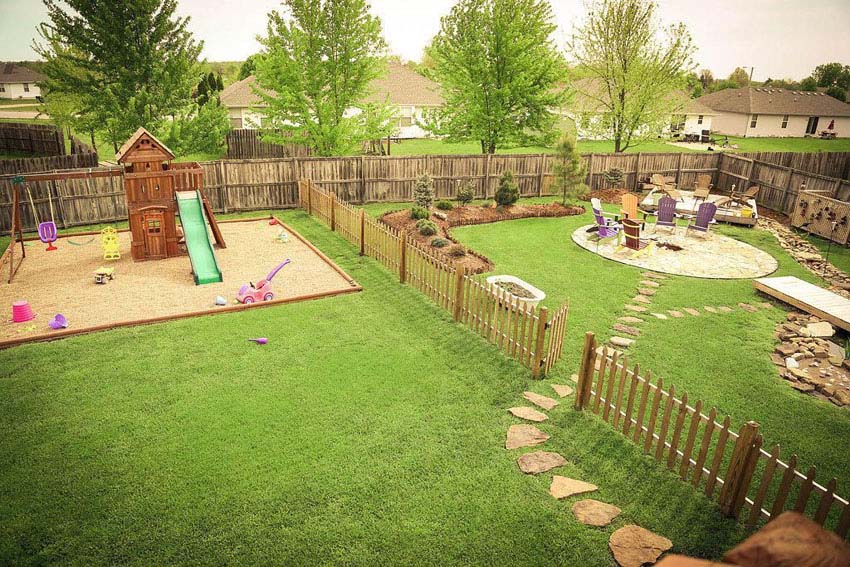 Backyard with wood picket fence with flagstone path
