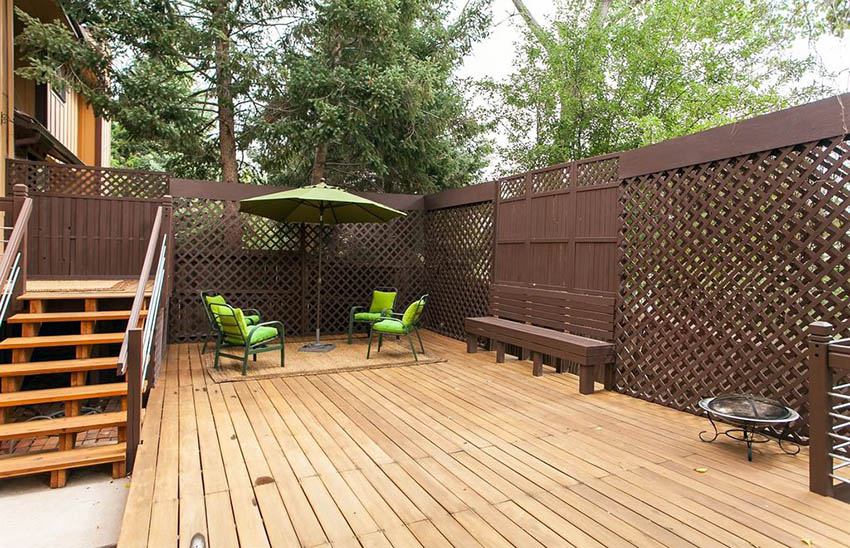 Deck with fence, wood stairs and outdoor umbrella