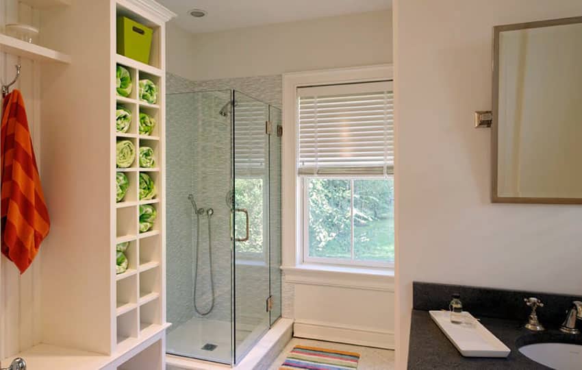 Bathroom with pivot shower door and black granite counter vanity