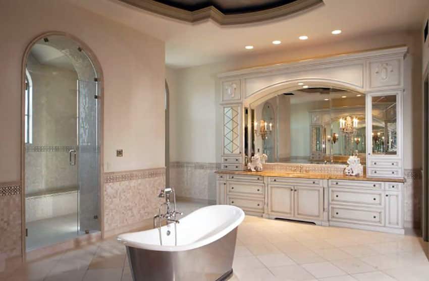 Beautiful bathroom with curved shower steam door and freestanding bathtub