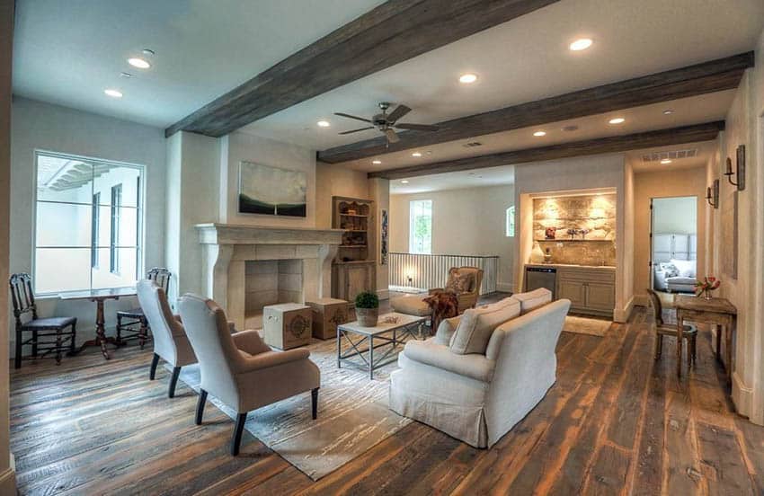 Beautiful living room with hand scraped hardwood floors and wood beam ceiling