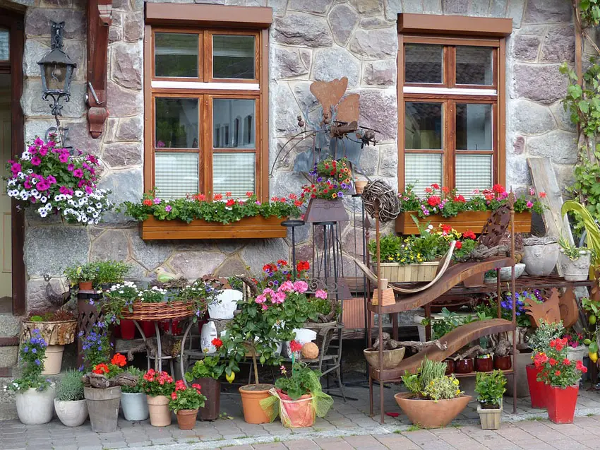 Beautiful wood flower boxes in windows of rustic stone house