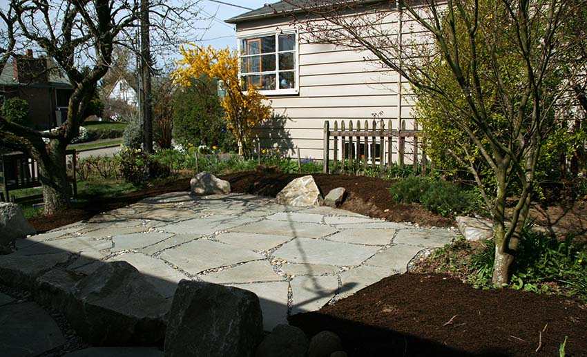 Building flagstone patio in backyard