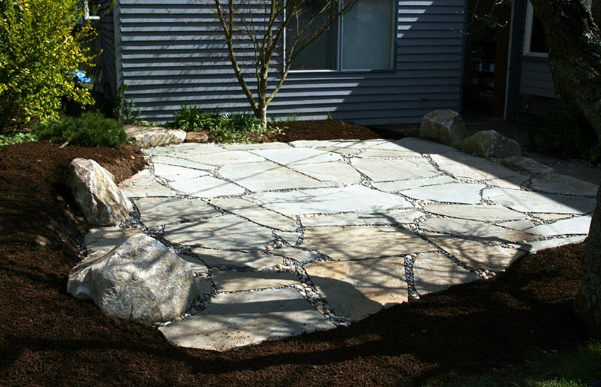 Building flagstone patio with bark border