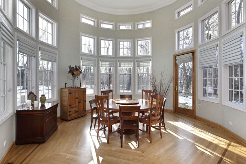 Circular sunroom with high ceiling and wood flooring