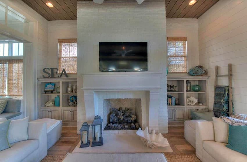 Coastal themed living room with fireplace and white furniture