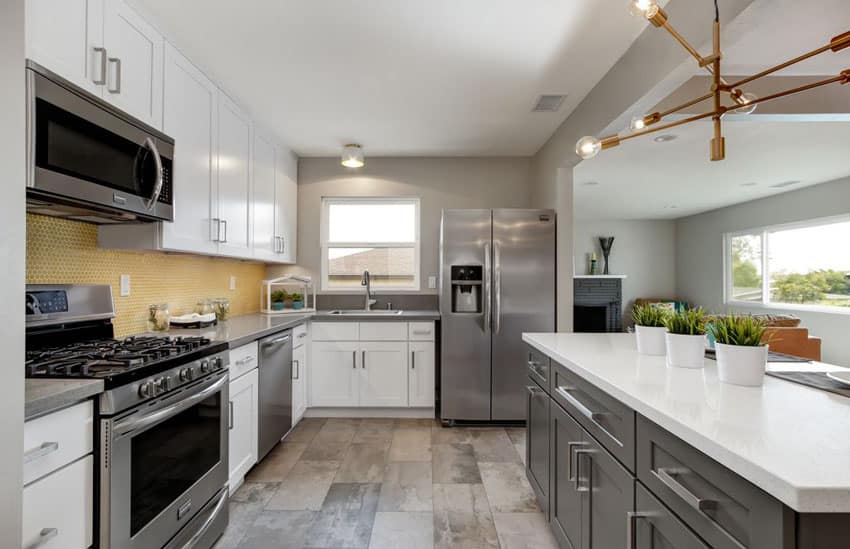 Contemporary kitchen with white and gray cabinets and arctic quartz countertops