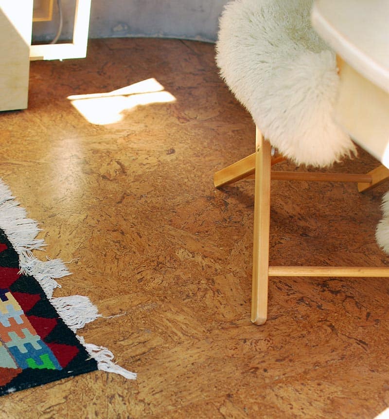 Cork flooring in living room with geometric rug