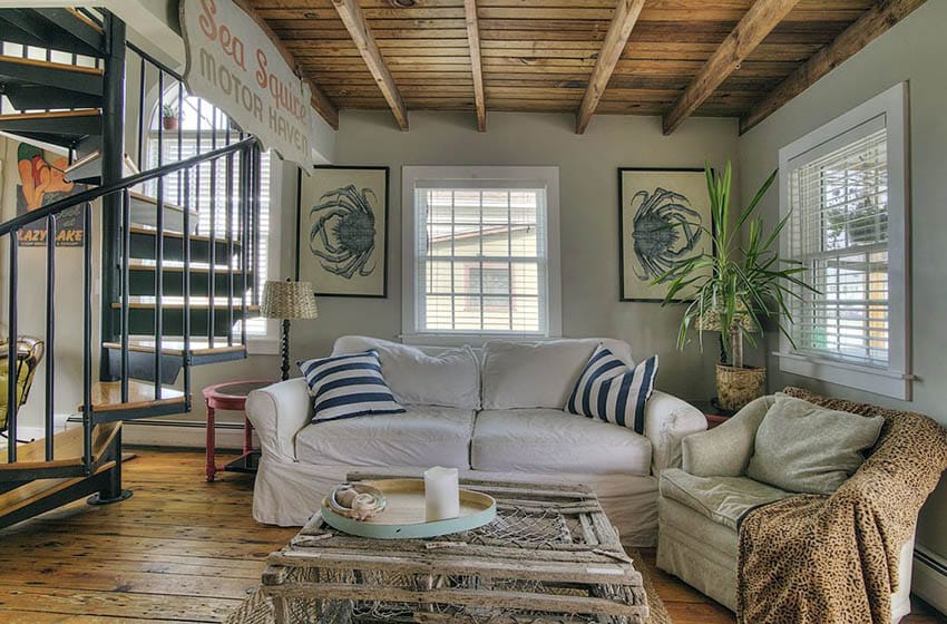 Cottage style living room with nautical theme ocean art and crab trap coffee table