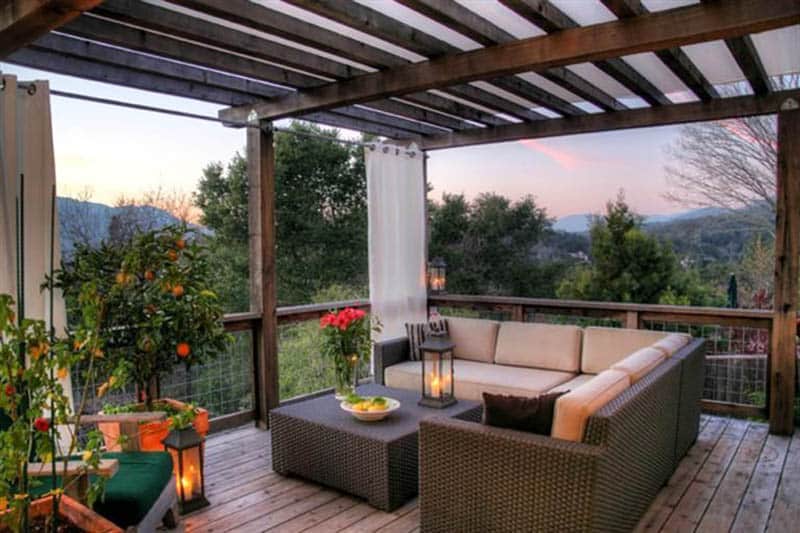 Deck pergola with white shade curtains and canopy