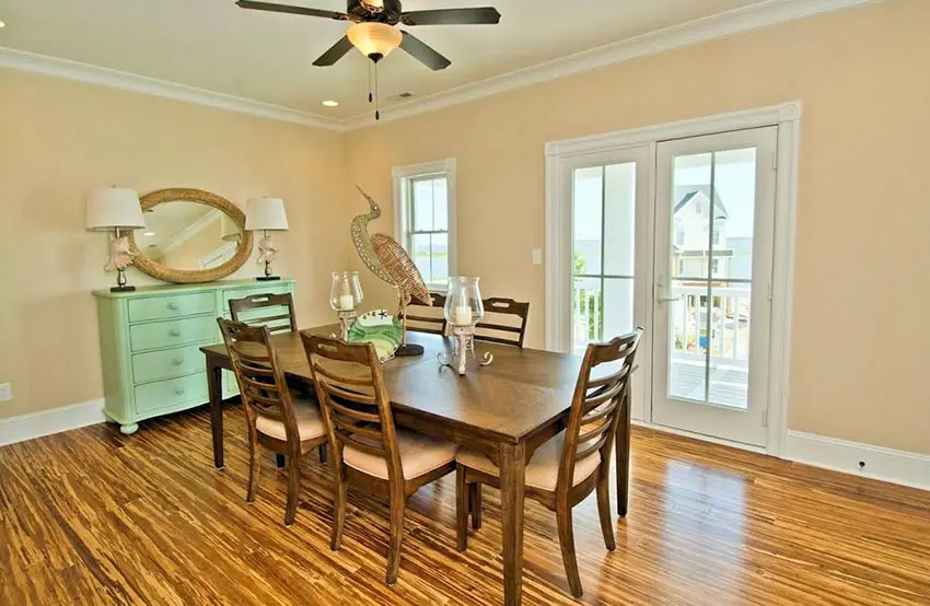 Room with dining set, ceiling fan and green console table