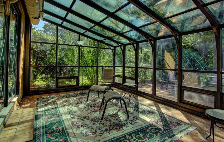 Enclosed back patio with glass windows and Spanish tile floors