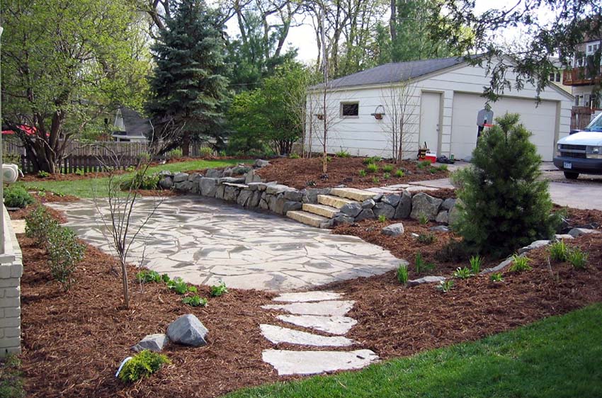 Flagstone patio area with bark border and stepping stones