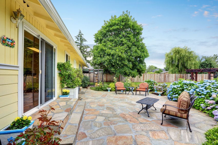 Patio at the of cute yellow house