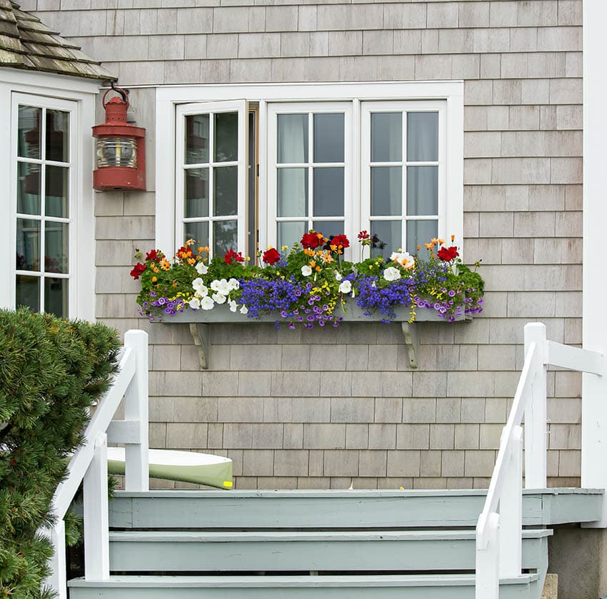 Front entry to home with window box with flowers