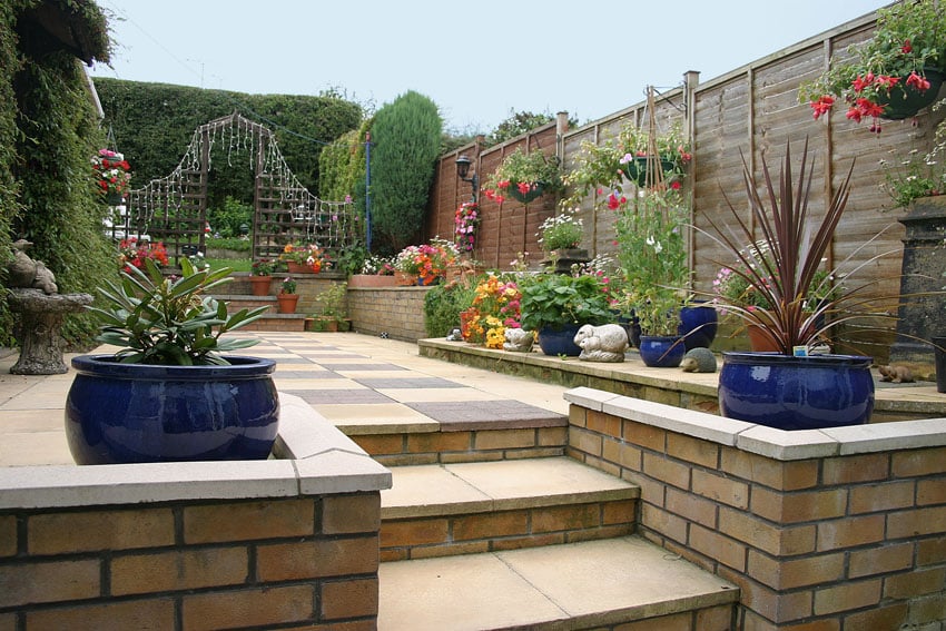 Backyard fence with flowers and hanging plant boxes