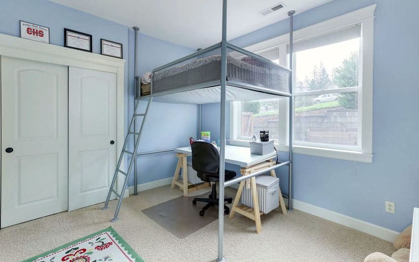 Kids blue bedroom with suspended bed with desk underneath
