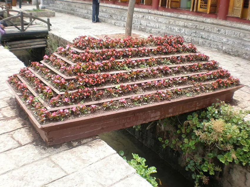 Large multi level flower box above water feature
