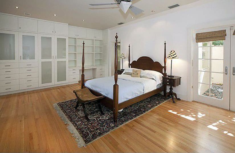 Master bedroom with built in storage, four poster bed and bamboo flooring