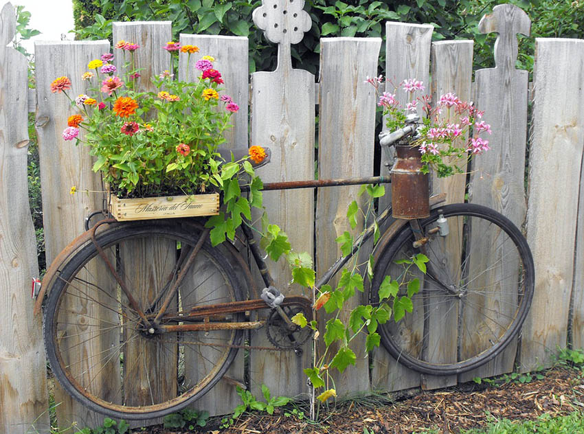 Old decorative bike fence plant container