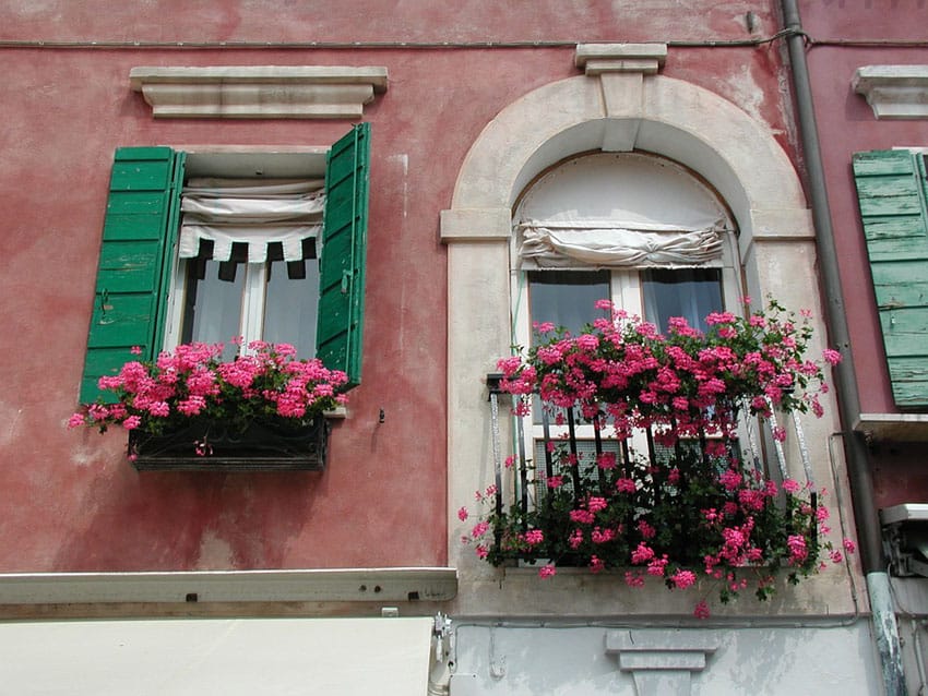 Old world home with rustic flower boxes in windows