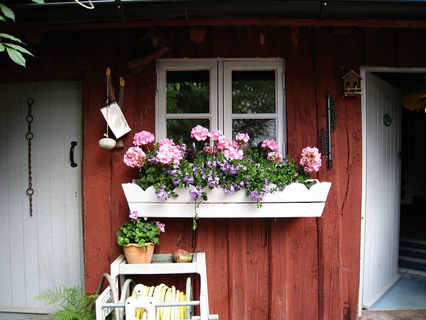 Painted wood flower box beneath window