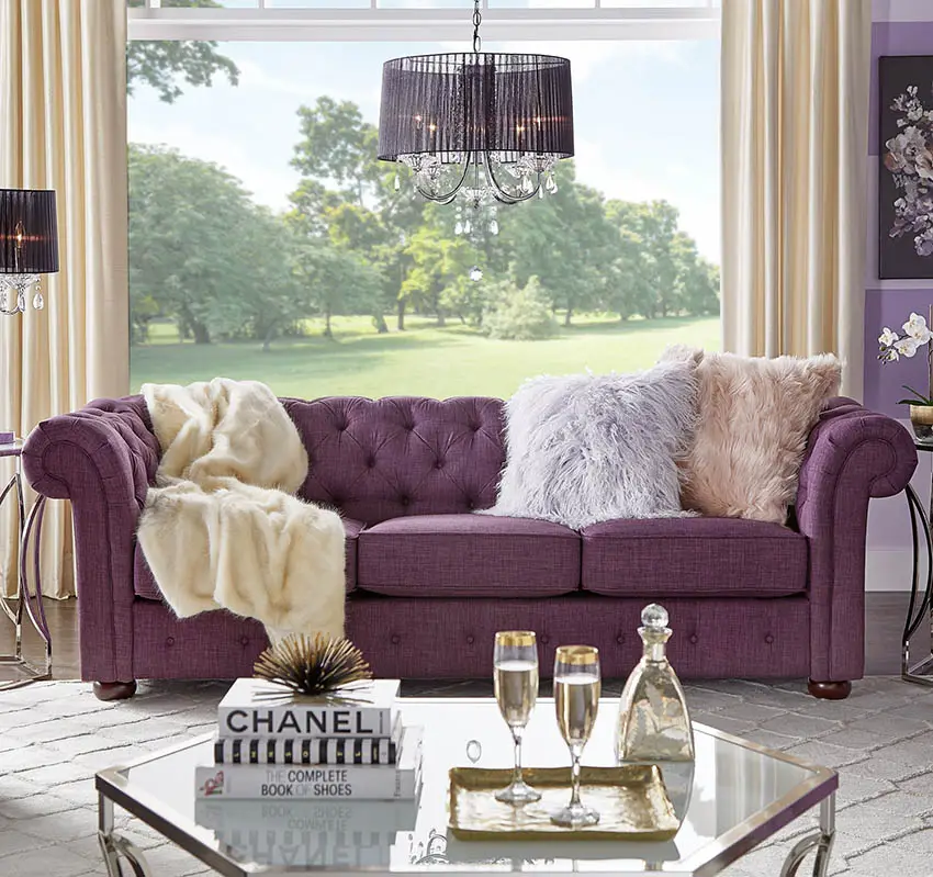 Purple tufted sofa with matching wall paint and lamp shade
