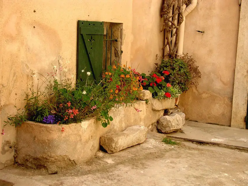 Rustic cement flower boxes in courtyard patio