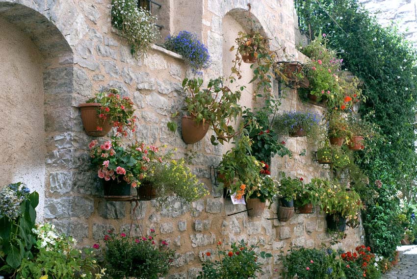 Rustic stone building with vertical flower garden