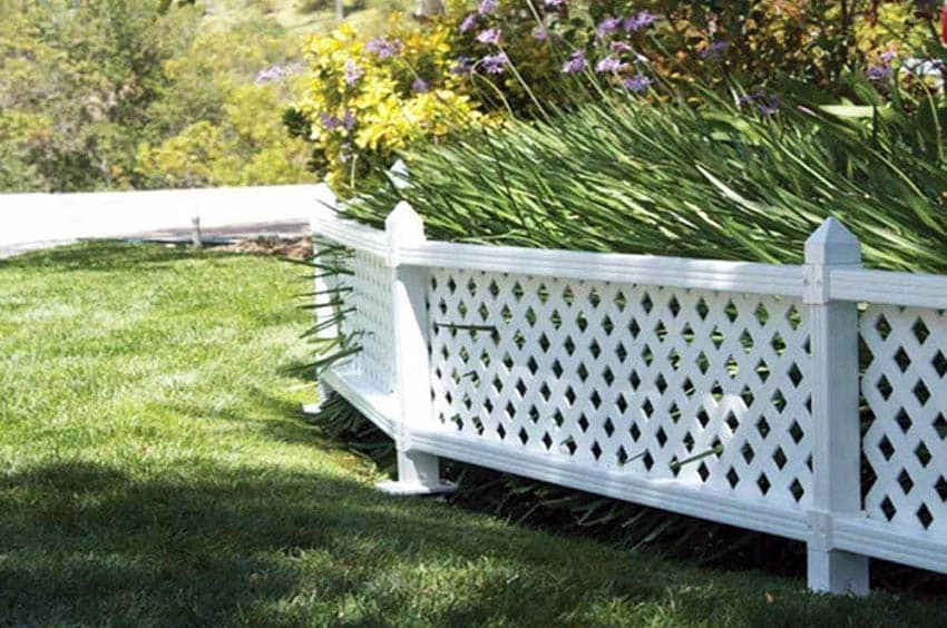 Short white vinyl fence panels in garden