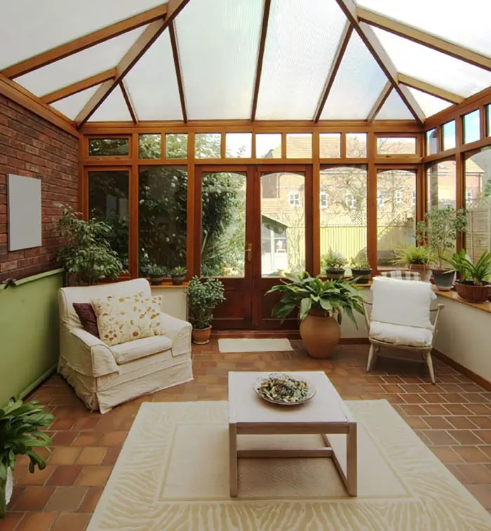Sunroom with terracotta floor tiles and cathedral ceiling with frosted glass