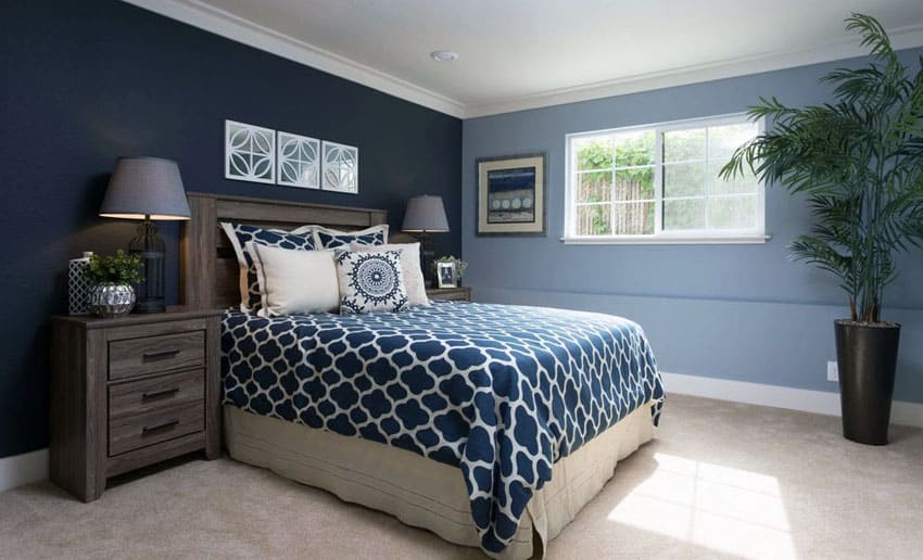 Two blue colors bedroom with picture window white molding and beige carpet
