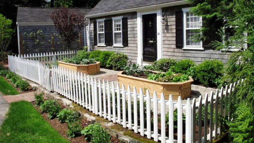 Fence around raised garden beds in front of the house