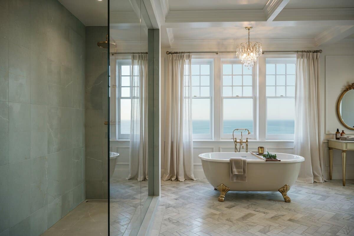 Bathroom with ocean view from bathtub and shower with chandelier