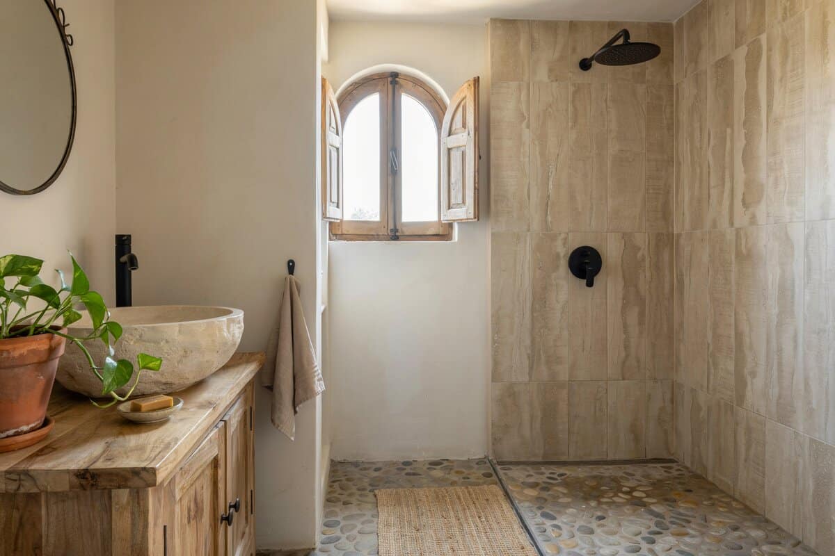 River rock shower with wood grain style porcelain tiles
