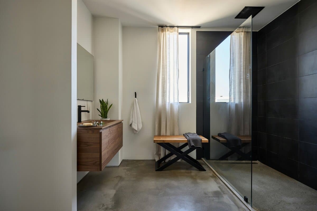 Bathroom with x-framed bench and graphic wall art