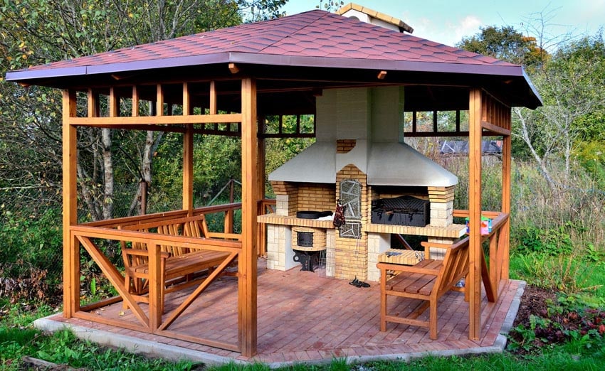 Backyard pavilion with benches and outdoor kitchen