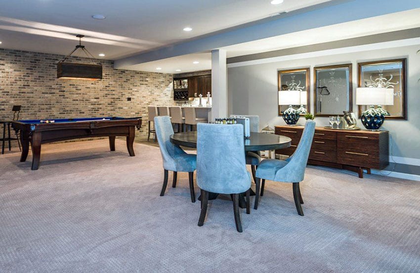 Basement room with pool table home bar and brick wall