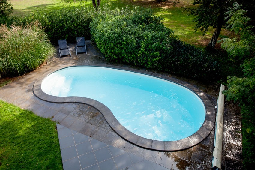 Beautiful kidney shaped pool with sitting patio