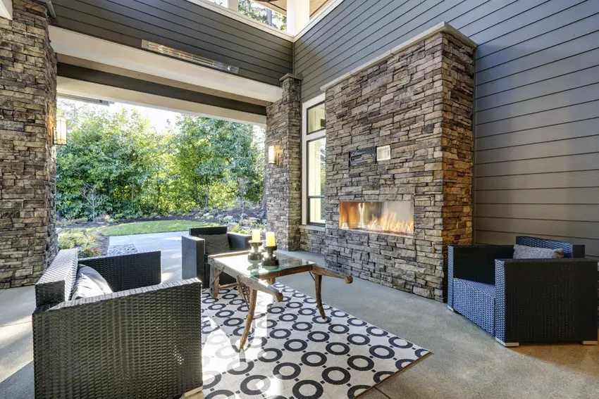 Patio with contemporary fireplace with stacked stone facade