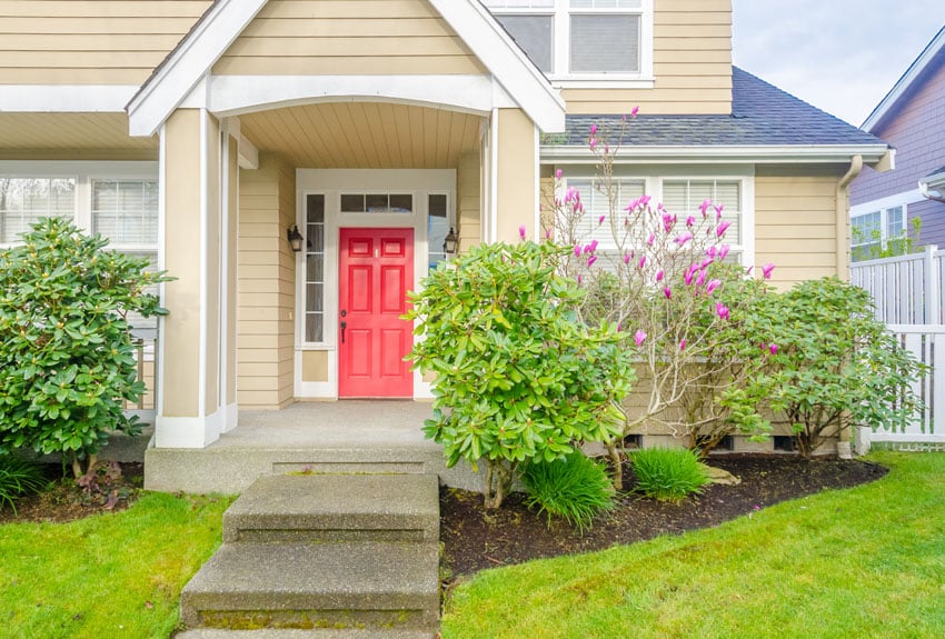 Bright red front door on yellow house