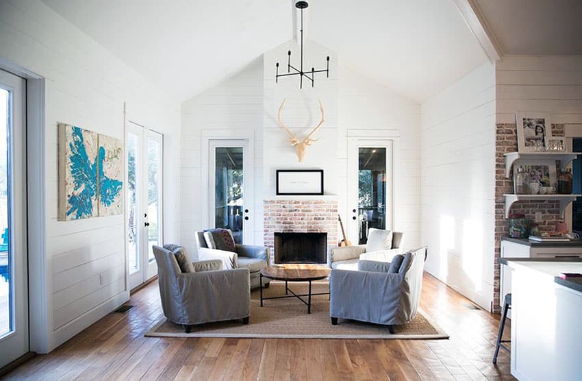 Cottage style living room with armchairs and brick fireplace