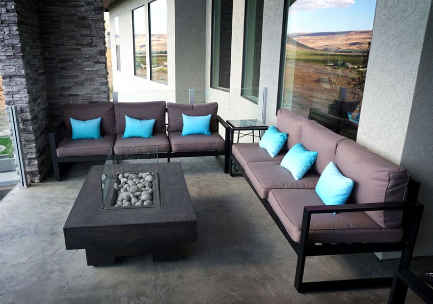 Patio with three seater sofa and turquoise pillows