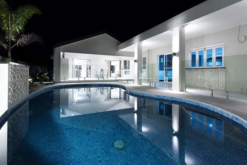 Kidney shaped swimming pool with blue mosaic tile