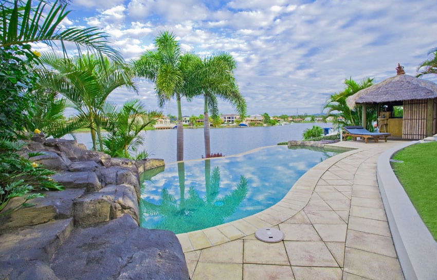 Infinity lagoon-look pool with river views and tiki hut bar