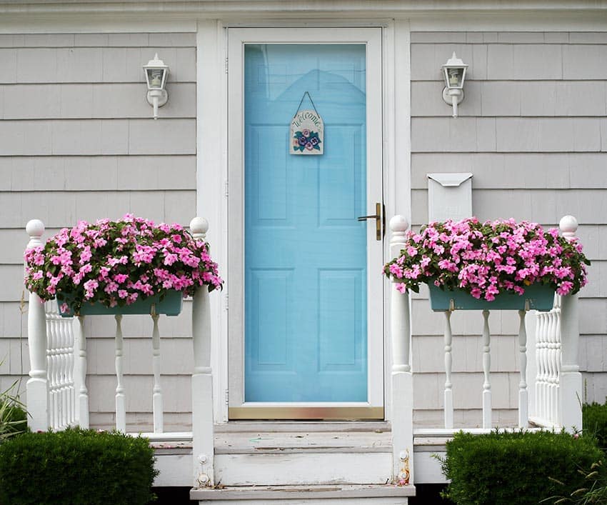 Light blue door color on gray house with flower boxes