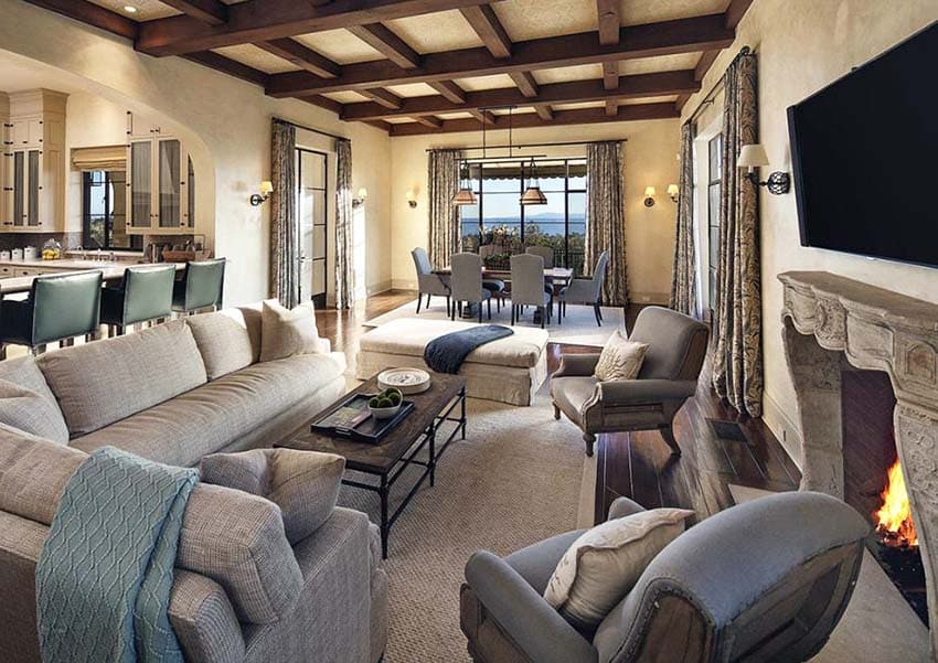 Living room with tv above fireplace and armchairs